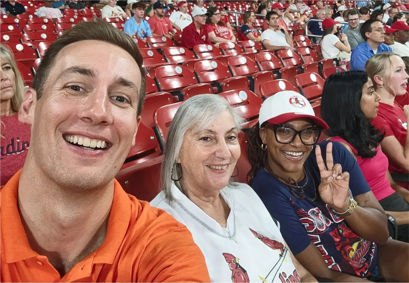 Jared Young takes a selfie with two Cardinals fans in the red seats at Busch Stadium