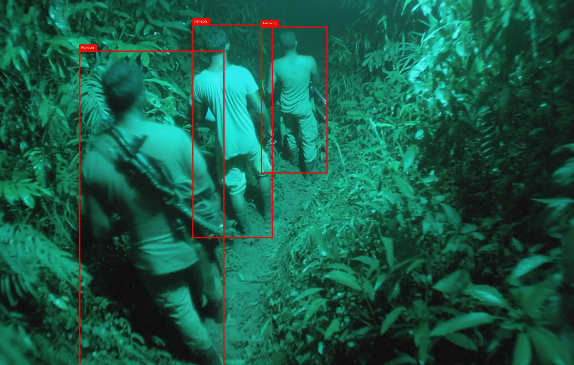 Art direction: three men moving through jungle in green night vision, each flagged by a red box