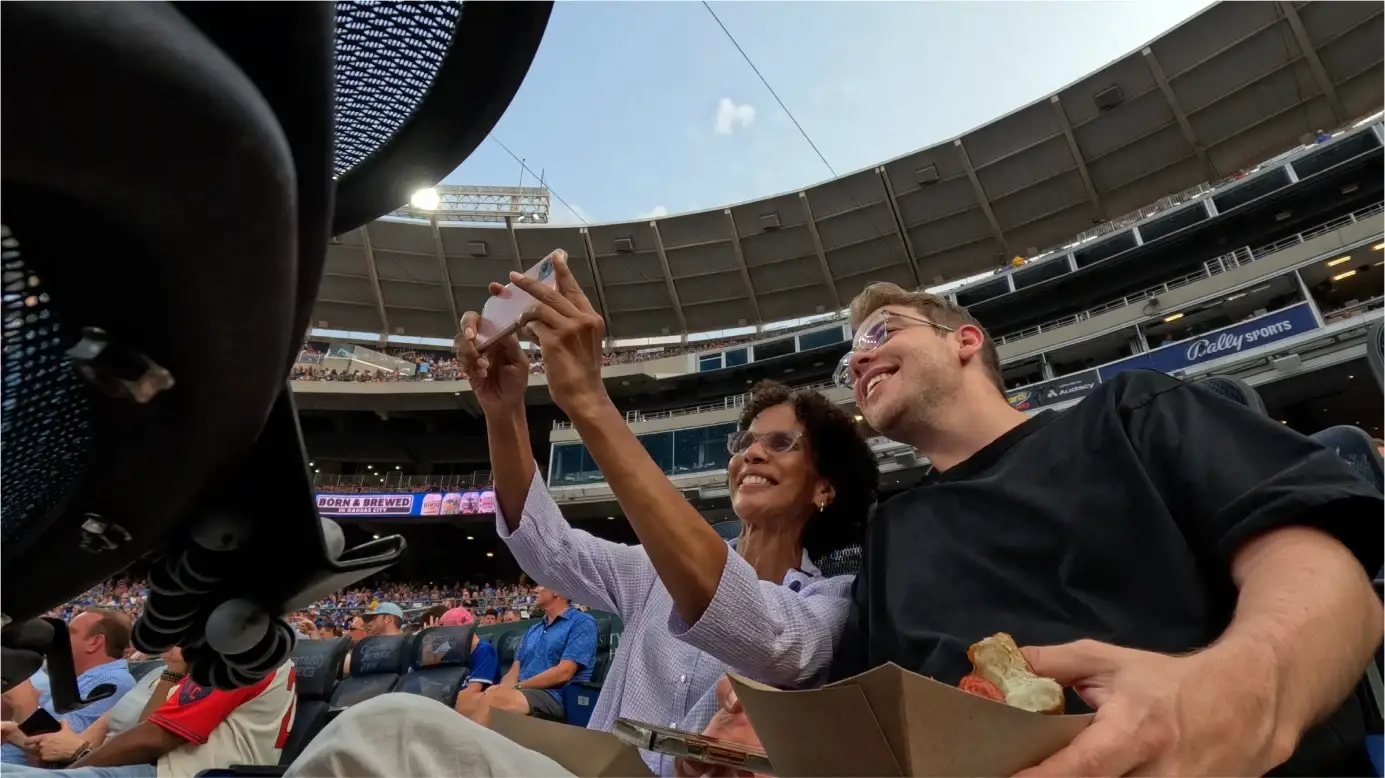 Kirby takes a selfie with Luke in their seats behind home plate at Kauffman Stadium